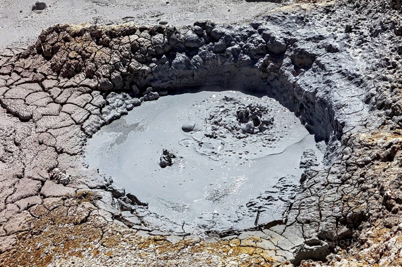 Small mud pool in eroded geothermal crater, The mud volcanoes and fumaroles on the Altiplano in Bolivia