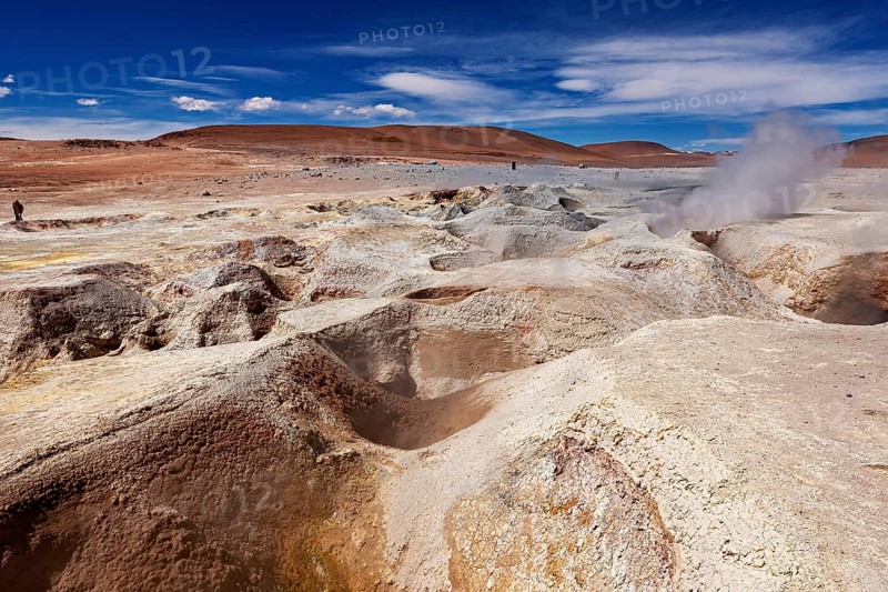 Barren desert landscape with geysers, rocks and vast skies conveys solitude, The mud volcanoes and fumaroles on the Altiplano in Bolivia