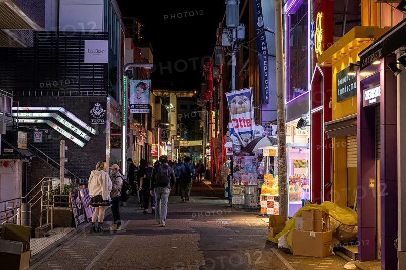 Tourists walk through the narrow alley of Takeshita-dori, Takeshita Street, with souvenir shops and restaurants in the Harajuku neighbourhood at night, tourist attraction, sight, Shibuya district, Tokyo, Japan