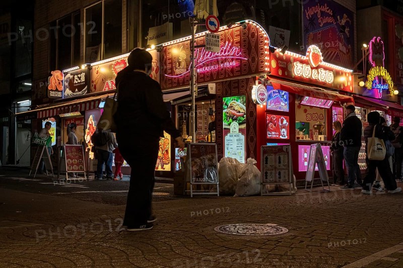 Tourists in front of a shop with illuminated advertisement for kebab and Japanese crepes in Takeshita-dori, Takeshita Street, alley with souvenir shops and restaurants in Harajuku neighbourhood at night, tourist attraction, sight, Shibuya district, Tokyo, Japan