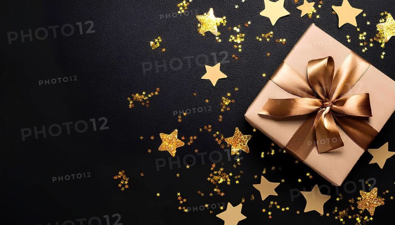 A gold-wrapped gift box with a satin ribbon placed on a black background, surrounded by glittering golden star confetti, creating a festive and luxurious holiday scene, AI generated