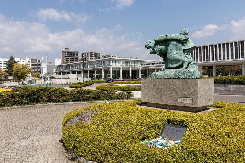 Statue of mother and children in the storm, bronze statue by the artist Shin Hongo in front of the Hiroshima Peace Museum, landmark, UNESCO World Heritage Site, peace memorial and memorial to the victims of the atomic bombing of Hiroshima in the Peace Park, Naka Ward, Hiroshima, Japan