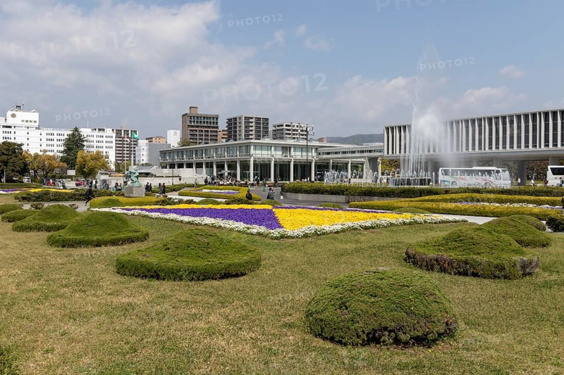 Colourful flower beds and fountains in front of the Hiroshima Peace Museum, tourist attraction, UNESCO World Heritage Site, peace memorial and memorial to the victims of the atomic bombing of Hiroshima in the Peace Park, Naka Ward, Hiroshima, Japan