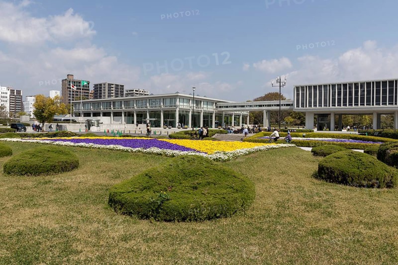 Colourful flower beds in front of the Hiroshima Peace Museum, tourist attraction, UNESCO World Heritage Site, peace memorial and memorial to the victims of the atomic bombing of Hiroshima in the Peace Park, Naka Ward, Hiroshima, Japan