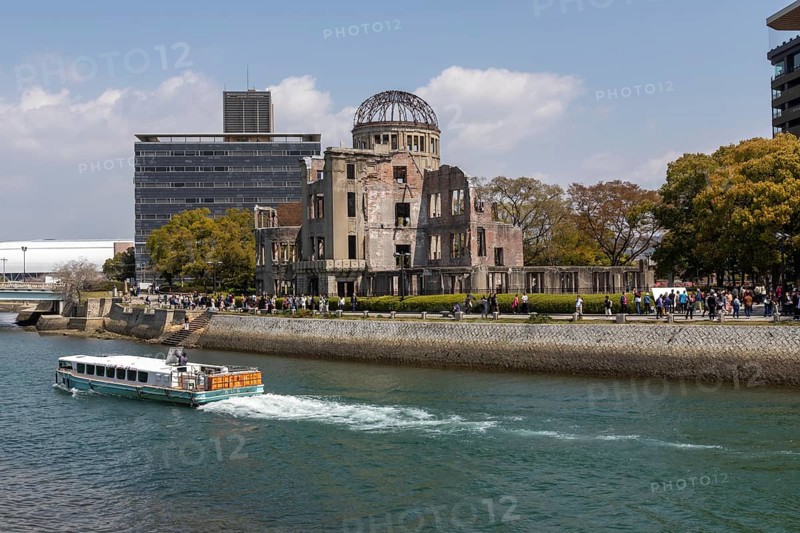Excursion boat and atomic bomb dome, Atomic Bomb Dome, ruins of the former Chamber of Commerce and Industry building, tourist attraction, UNESCO World Heritage Site, peace memorial and memorial to the victims of the atomic bombing of Hiroshima in the Peace Park on the Otagawa River, Naka Ward, Hiroshima, Japan