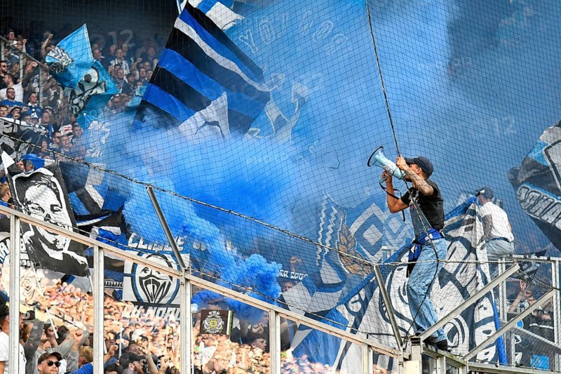 Borussia Park Mönchengladbach, 24.8.2025 Football: Bundesliga Season 2025/26 1st Matchday, Borussia Mönchengladbach (BMG, white) vs Hamburger Sportverein (HSV, blue) _ Pre-singer and Ultra HSV Fans in the guest fan block in blue smoke _ DFL REGULATIONS PROHIBIT ANY USE OF PHOTOGRAPHS AS IMAGE SEQUENCES AND/OR QUASI-VIDEO