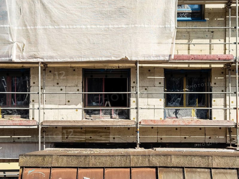 Scaffolding on a building being insulated with thermal insulation panels, Wuppertal, Germany