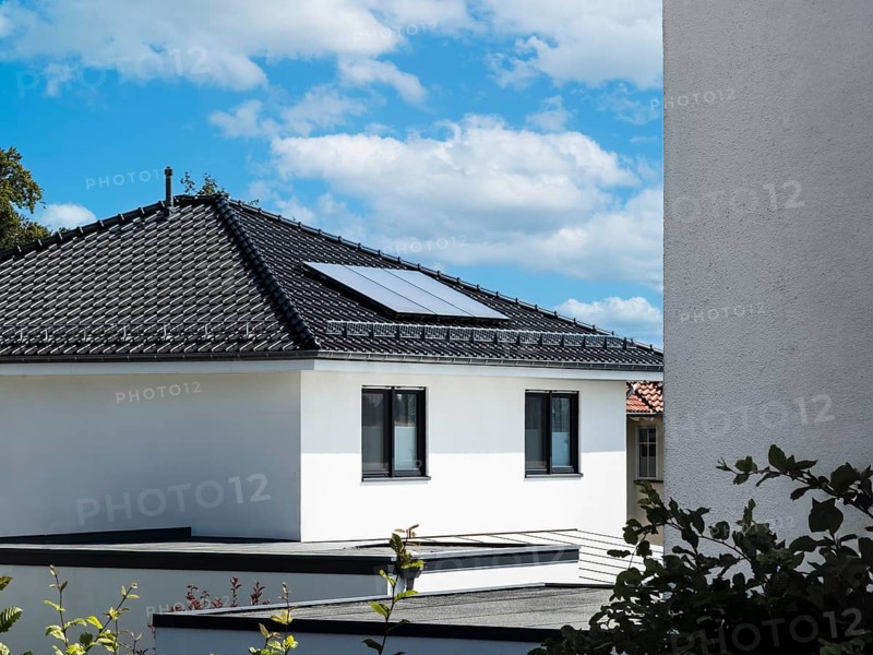 Solar panels on the roof of a new-build detached house in Radevormwald, Germany, digitally reworked