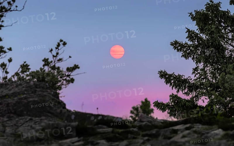 Sunset coloured by smoke particles in the atmosphere. Großer Feldberg in the Taunus, Hesse, Germany