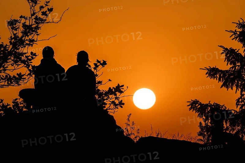 Silhouettes in front of the setting sun. Großer Feldberg in the Taunus, Hesse, Germany
