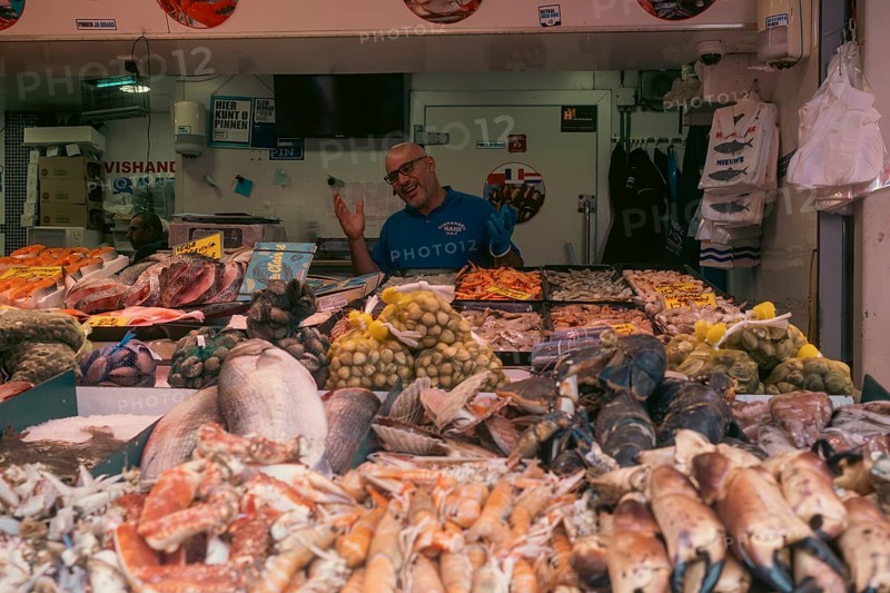 Market vendor with fresh catch at the weekly market market. De Haagse Markt, The Hague, Netherlands