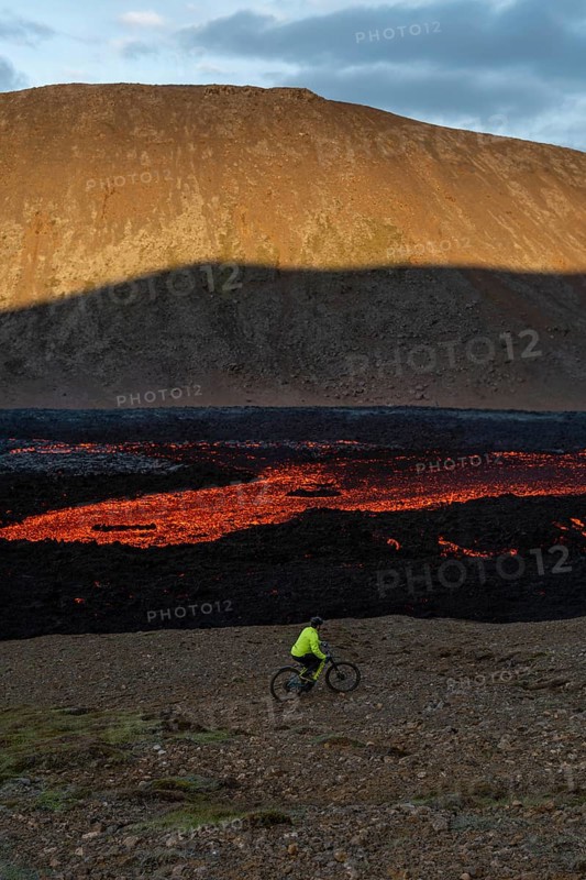 Mountain biking next to flowing lava and an active volcano. Fagradalsfjall, Reykjanes, Iceland