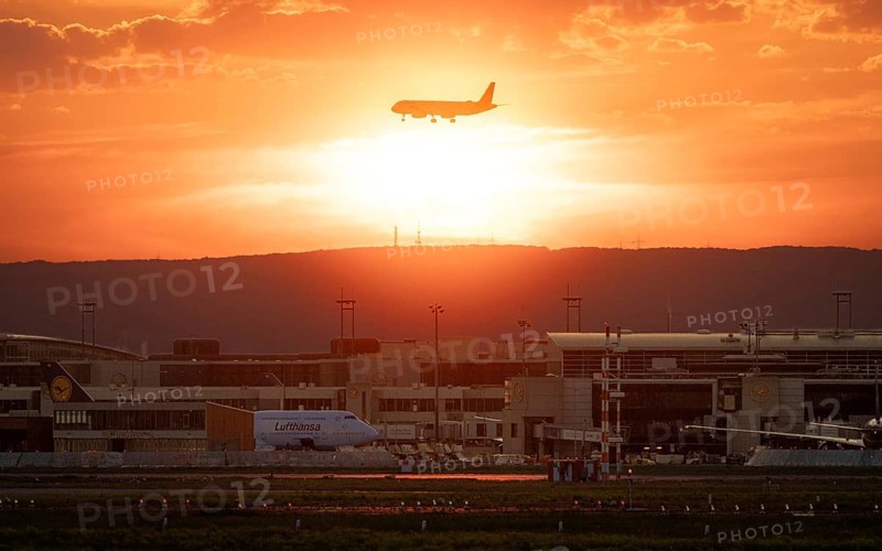 Plane on final approach at sunset. Frankfurt am Main Airport, Hesse, Germany