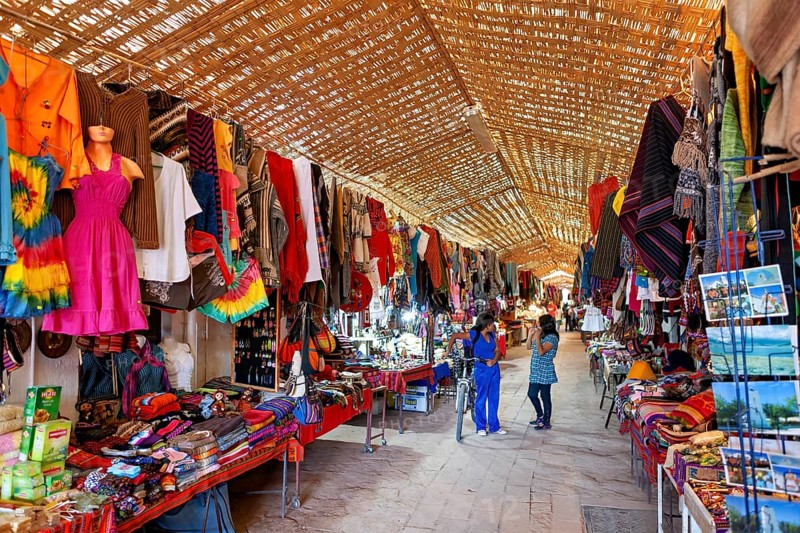 A lively market with a variety of colourful clothing, textiles and souvenirs. Traditional crafts and hustle and bustle, The market with souvenir shops in San Pedro de Atacama in Chile