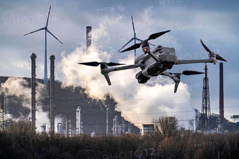 Symbolic image, photomontage, reconnaissance, spying with drones in industrial plants, critical infrastructure, drone flies towards an industrial complex, chemical plant, spying by camera drones