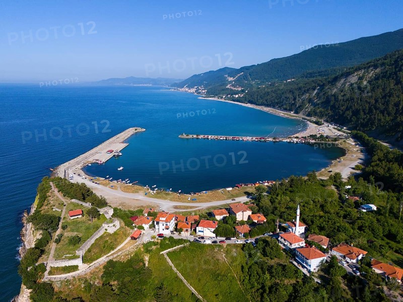 Aerial view of a coastal town with red roofs surrounded by green hills and calm blue sea, aerial view, Ginolu Bay, Ginolu, Kastamonu Province, Turkey