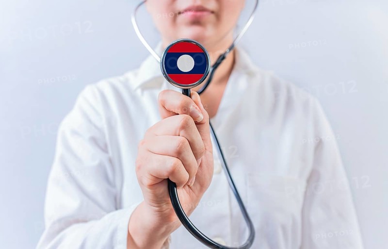 Female doctor holding stethoscope with Laos flag. National health system of Laos