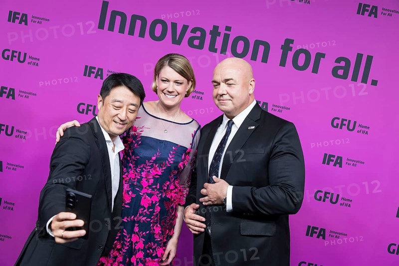 Sara Warneke (Managing Director of gfu Consumer & Home Electronics GmbH, centre) and Leif-Erik Lindner (Managing Director of IFA Management GmbH, right) have their photo taken in front of the opening gala of the IFA Funkausstellung in the CityCube, Berlin, 4 September 2025