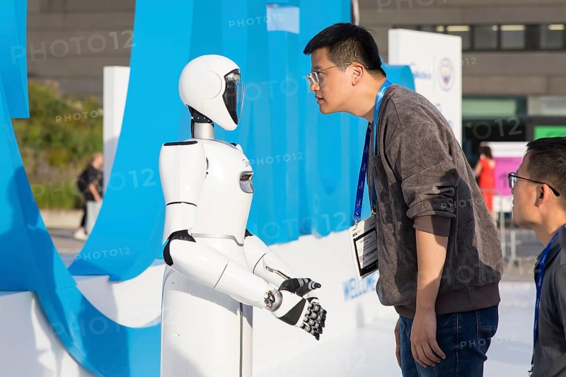A person looks at a robot at the IFA consumer electronics exhibition on the exhibition grounds, Berlin, 04/09/2025
