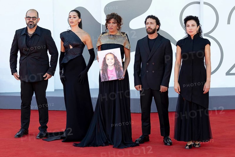 Venice, Italy - 3 September 2025: Amer Hlehel, Saja Kilani, Kaouther Ben Hania, Motaz Malhees and Clara Khoury, with a portrait of five-year-old Palestinian girl Hind Rajab, who was killed by the Israeli army in the Gaza Strip in January 2024, during the Red Carpet of - The Voice Of Hind Rajab - during the 82nd Venice International Film Festival