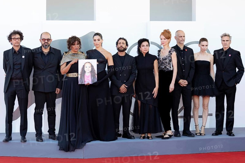 Venice, Italy - 3 September 2025: Nadim Cheikhrouha, Amer Hlehel, Kaouther Ben Hania, Saja Kilani, Motaz Malhees, Clara Khoury, Odessa Rae, James Wilson, Rooney Mara and Joaquin Phoenix with a portrait of the five-year-old Palestinian girl Hind Rajab, who was killed by the Israeli army in the Gaza Strip in January 2024, during the red carpet of - The Voice Of Hind Rajab - during the 82nd Venice International Film Festival. Venice International Film Festival