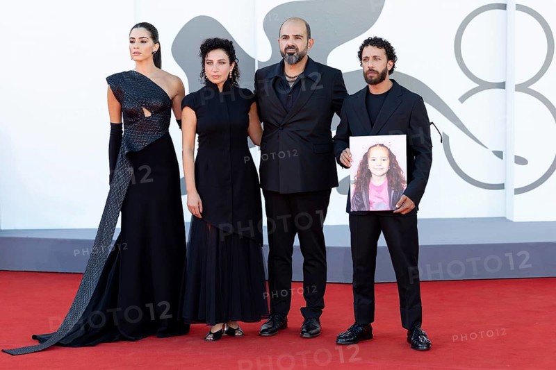Venice, Italy - 3 September 2025: Saja Kilani, Clara Khoury, Amer Hlehel, Kaouther Ben Hania, Saja Kilani, Motaz Malhees, with a portrait of the five-year-old Palestinian girl Hind Rajab, who was killed by the Israeli army in Gaza in January 2024, during the Red Carpet of - The Voice Of Hind Rajab - during the 82nd Venice International Film Festival