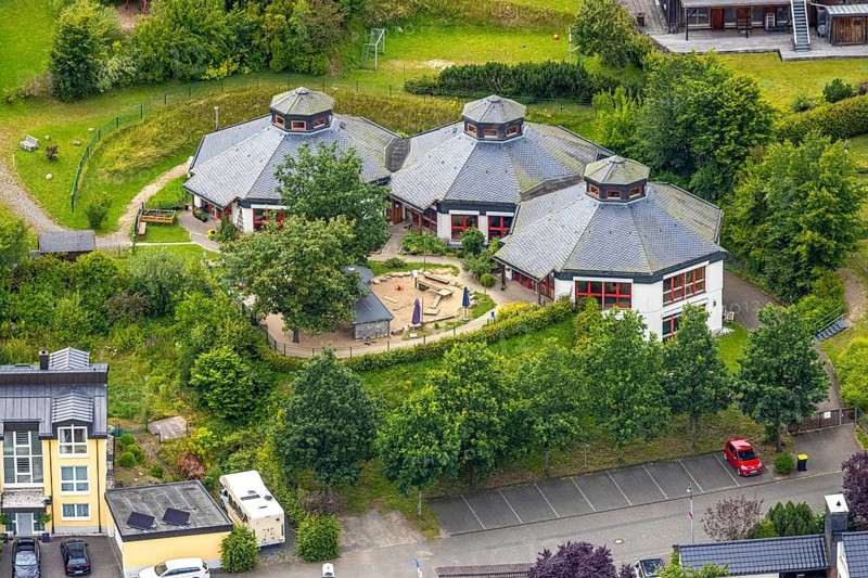 Aerial view, AWO Family Centre Laubfrosch Kindergarten, octagonal building and playground, Bad Berleburg, Wittgensteiner Land, North Rhine-Westphalia, Germany, AWO Family Centre Laubfrosch, architecture, outdoor area, contemplation, education, village, facilities, parents, educators, upbringing, leisure, early childhood education, building, community, green spaces, infrastructure, children, kindergarten, kindergarten children, landscape, nature, perspective, summer, social centre, play equipment, playground, structure, daylight, entertainment, octagonal, rural, educational, public facilities