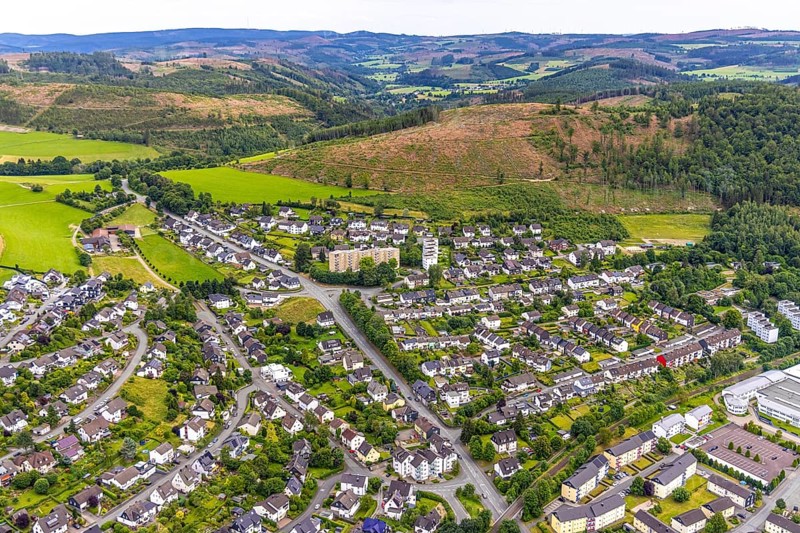 Aerial view, high-rise buildings and housing estate on Brandenburger Straße, forest area with forest damage and distant view, Bad Berleburg, Wittgensteiner Land, North Rhine-Westphalia, Germany, architecture, Brandenburger Straße, trees, drone image, distant view, forestry, buildings, high-rise buildings, real estate, infrastructure, landscape, nature, panorama, damage, settlement, city, urban development, environment, urban, forest area, forest damage, housing estate, flats, rural