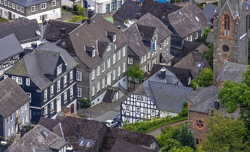Aerial view, Protestant town church and green trees on Schlossstraße, residential area with historic houses, Bad Berleburg, Wittgensteiner Land, North Rhine-Westphalia, Germany, old town, architecture, view, roof, monument, village, building, faith, green trees, home, church, cultural heritage, landscape, nature, panorama, religion, Schlossstraße, summer, city, city view, cityscape, daylight, residential area, authentic, European city, Protestant town church, peaceful, cosy, historic houses, rural