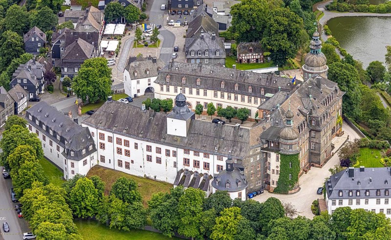 Aerial view, Berleburg Castle, residential castle of the Sayn-Wittgenstein family, Bad Berleburg, Wittgensteiner Land, North Rhine-Westphalia, Germany, noble family, architecture, exterior, castle, trees, roofs, heritage, Sayn-Wittgenstein family, building, culture, landscape, nature, panoramic view, residence, residential castle, palace, sight, tourism, tradition, environment, landmark, European, stately, historic, rural, medieval