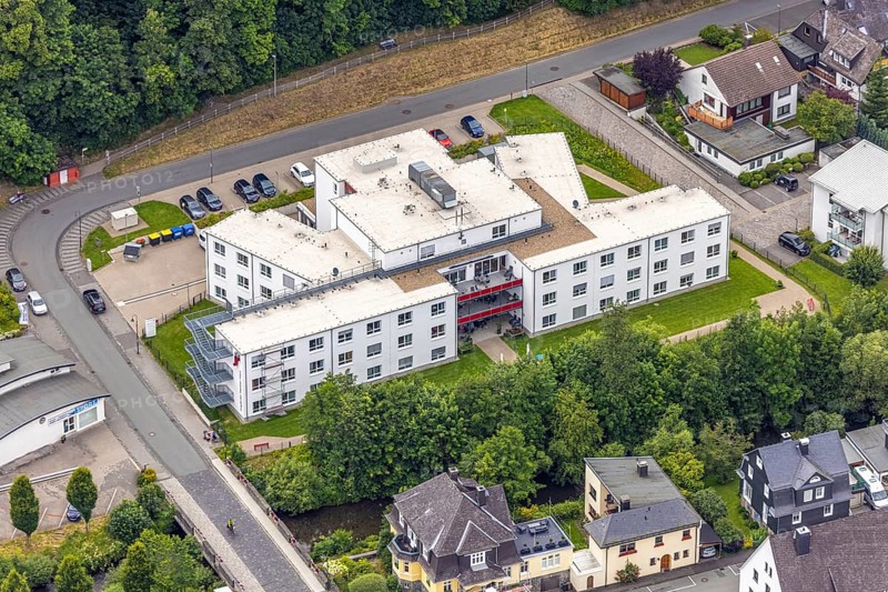 Aerial view, Friederike-Fliedner-Haus retirement home, Evang. Johanneswerk gGmbH nursing home, Mühlwiese, Bad Berleburg, Wittgensteiner Land, North Rhine-Westphalia, Germany, retirement home, old people's home, architecture, exterior view, care, village, facility, Evang. Johanneswerk gGmbH, Friederike-Fliedner-Haus, building, healthcare, green space, infrastructure, municipality, landscape, aerial view, care, care facility, nursing home, care for the elderly, retirement home, environment, residential building, institutional, rural