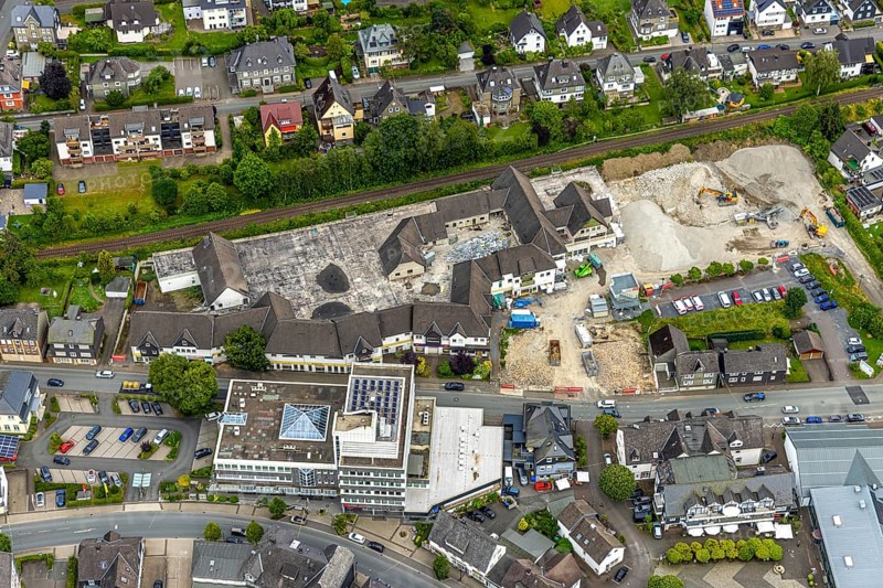 Aerial view, car park demolition and demolition of the former Eins-A complex on Schulstrasse, commercial building on Schulstrasse, Bad Berleburg, Wittgensteiner Land, North Rhine-Westphalia, Germany, demolition, demolition, demolition work, labour, architecture, construction work, construction site, Eins-A complex, progress, building, site, commercial building, trade, helicopter perspective, infrastructure, infrastructure project, construction, aerial view, machinery, modernisation, car park, region, renovation, Schulstrasse, summer, town, urban development, street view, structure, daylight, urban, change, tools, reconstruction, destruction