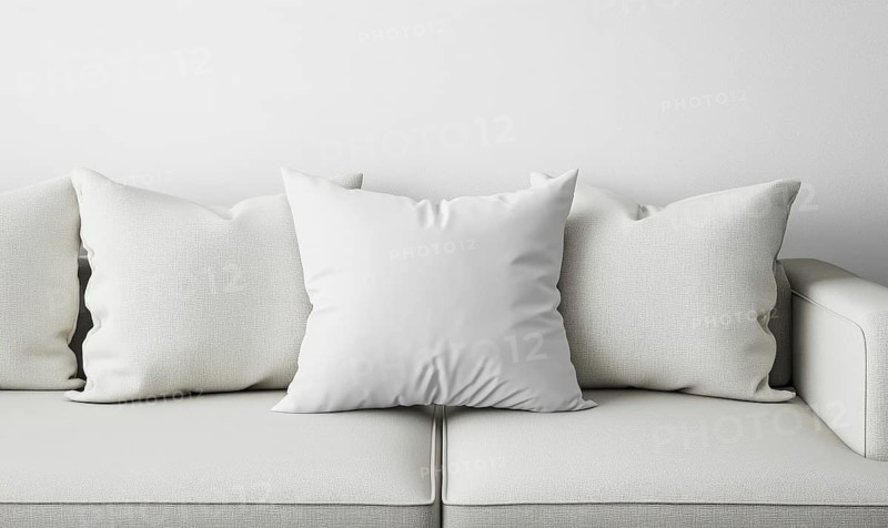 A minimalist white sofa adorned with soft pillows creates a serene and modern setting. AI generated