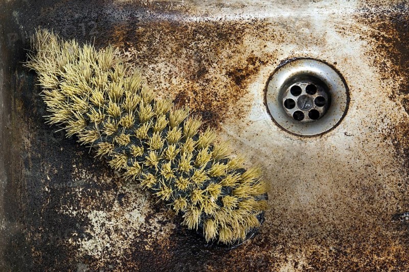 Detail shot of a old dirty sink with scrubber inside