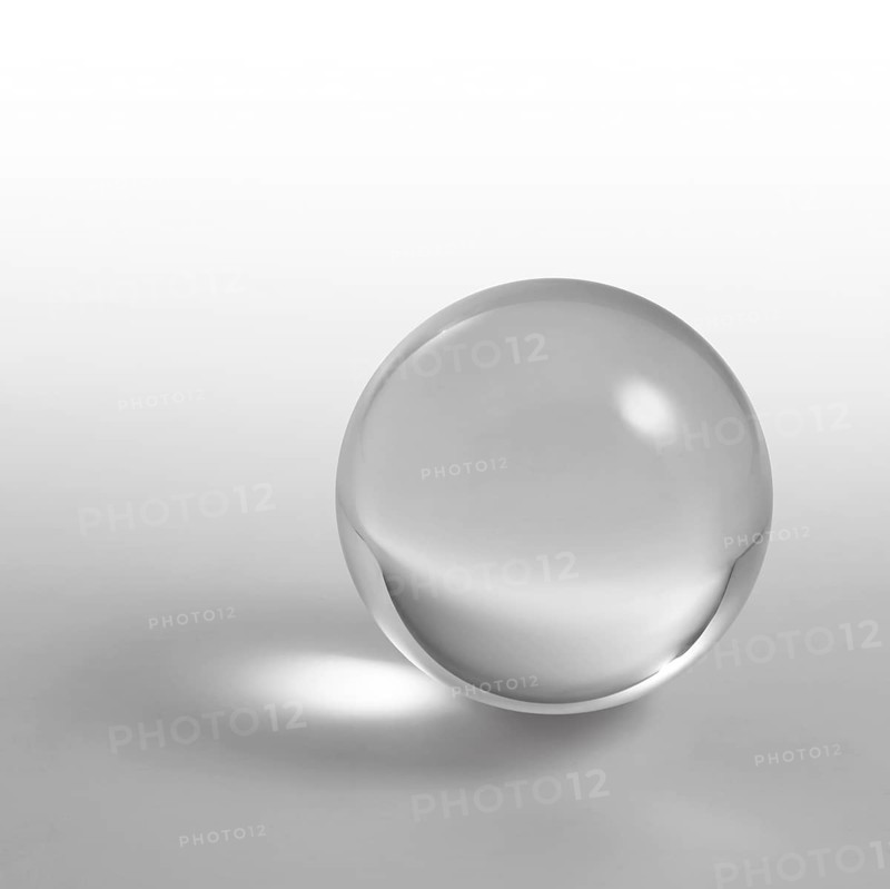 A clear crystal ball and light reflections in grey gradient back