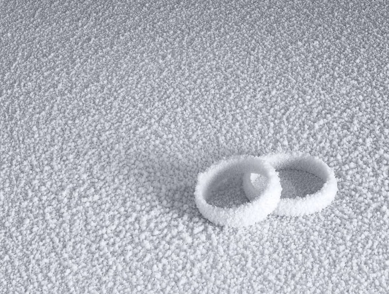 Studio photography of two frosted wedding rings in cold ambiance