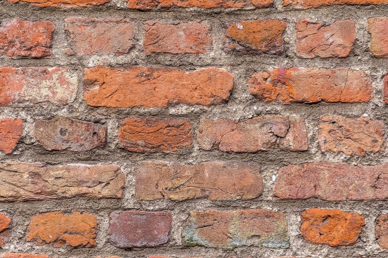 Full frame rundown red brick wall detail