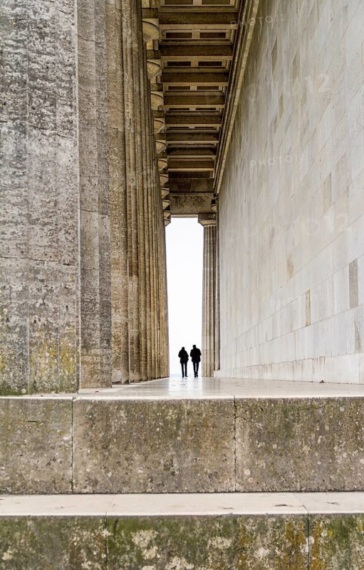 Colonnade and two human silhouettes at the Walhalla memorial near Regensburg in Bavaria, Gerrmany