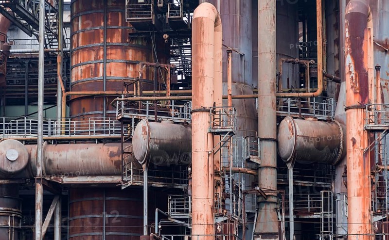 Weathered rusty industrial scenery with old corroded steel girders and metal tubes