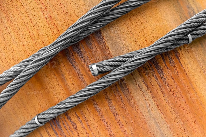 Closeup shot of wire ropes on rusty ground