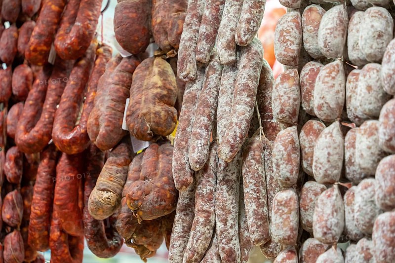 Closeup shot showing various air-dried salame sausages seen in Italy