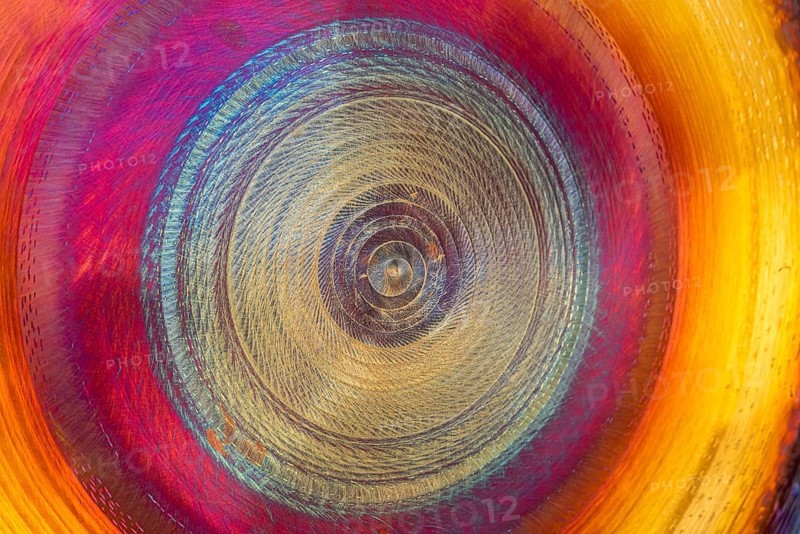 Full frame abstract detail shot of a colorful metallic gong