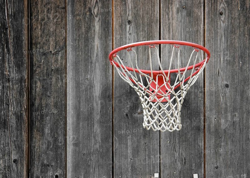 A basketball basket on weathered wooden facade