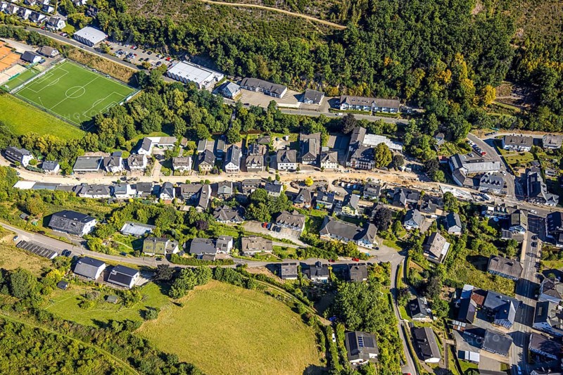 Aerial view, Hundemstraße road construction work with closure, football stadium sports field FC Kirchhundem 1946 and tennis court TC Rot-Weiß Kirchhundem, residential area, Kirchhundem, Sauerland, North Rhine-Westphalia, Germany, construction work, construction area, building site, building plots, construction measure, construction project, construction site, DE, Europe, football, football field, football stadium, property tax, real estate, aerial view, aerial photography, aerial photography, new construction, sports, sports facility, sports field, tennis, tennis facility, tennis court, tennis courts, tennis club, overview, bird's-eye view, residential complex, housing and living, quality of living, residential neighbourhood, housing estate, residential area, birds-eyes view, overview