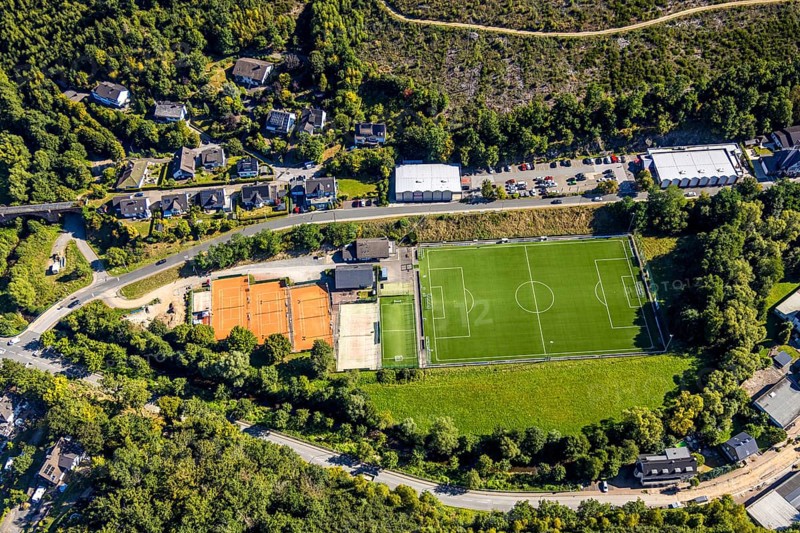 Aerial view, football stadium sports field and tennis court at Bahnhofsweg of FC Kirchhundem 1946 e.V., Rewe supermarket, Kirchhundem, Sauerland, North Rhine-Westphalia, Germany, DE, shopping, shopping centre, shopping markets, shopping square, shopping centre, Europe, football, football field, football stadium, aerial view, aerial photography, aerial photography, local supply centre, sports, sports facility, sports field, supermarket, tennis, tennis facility, tennis court, tennis courts, tennis club, overview, bird's-eye view, overview
