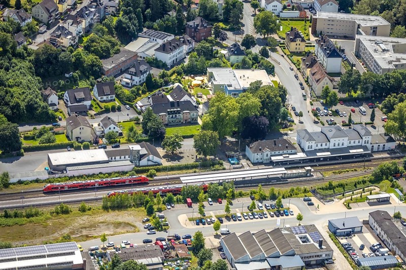 Aerial view, Arnsberg-Neheim-Hüsten railway station, Hüsten, Arnsberg, Sauerland, North Rhine-Westphalia, Germany, railway station, Arnsberg-Neheim-Hüsten, train, tracks, rails, building, architecture, city, traffic, transport, infrastructure, region, landscape, surroundings, bridge, roads, cars, trees, roofs, trains, journey, destination, station, sky, perspective, above, summer, day, clouds, urban