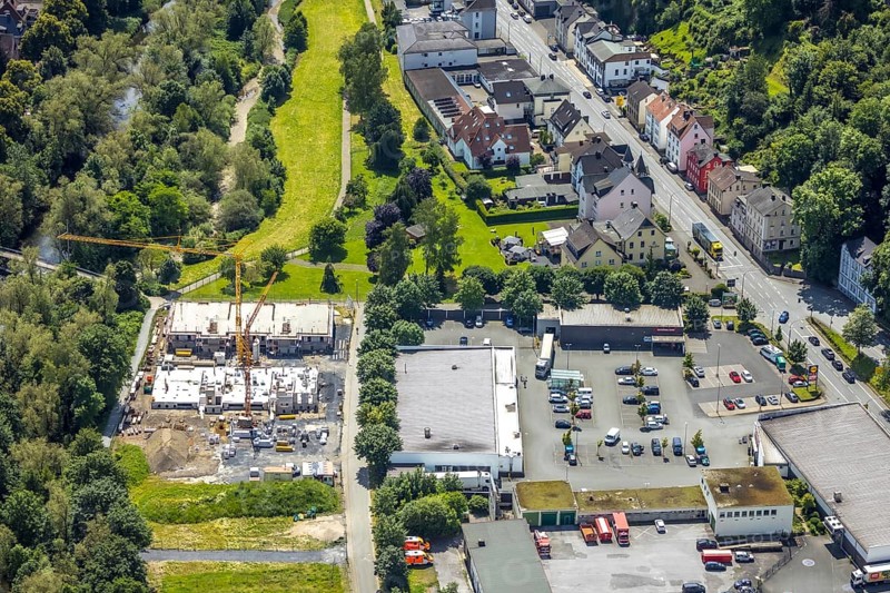 Aerial view, construction site with new building next to the fire brigade fire station on the river Ruhr, Obereimer, Arnsberg, Sauerland, North Rhine-Westphalia, Germany, construction site, new building, fire brigade, fire station, river, Ruhr, building, construction, architecture, city, river bank, landscape, infrastructure, development, urban, water, green areas, industry, residential area, construction project, modern, from the air, helicopter, bird's eye view, construction cranes, blue, green, order, planning