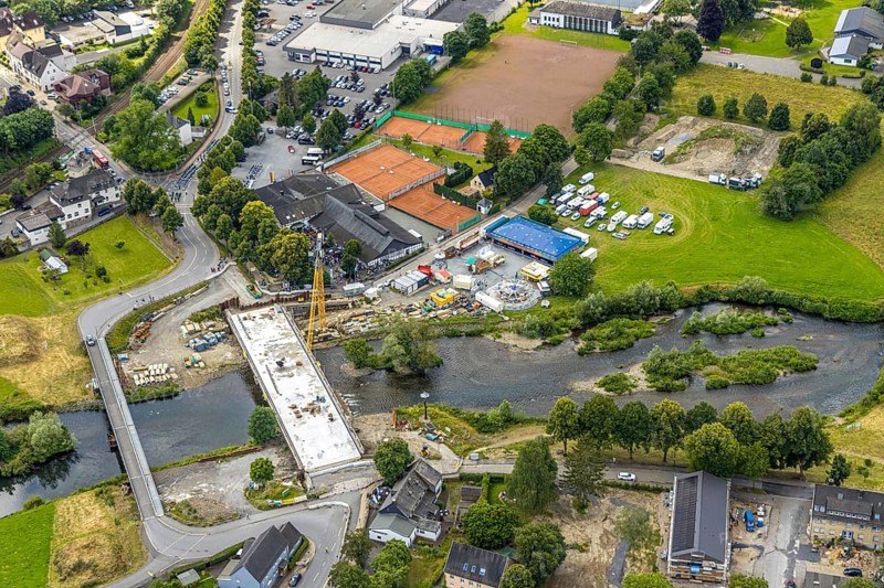 Aerial view, temporary bridge and construction site with new construction of the Dinscheder Ruhrbrücke Glösinger Straße (L735) over the river Ruhr and renaturalisation, Glösingen, Arnsberg, Sauerland, North Rhine-Westphalia, Germany, temporary bridge, construction site, new construction, Dinscheder Ruhrbrücke, Glösinger Straße, L735, river Ruhr, Renaturation, bridge, infrastructure, construction work, river, landscape, construction, environment, modernisation, transport project, summer, daylight, clouds, construction cranes, construction equipment, technology, architecture, nature, water, transport, urban development, region, development, aerial view, German city, project