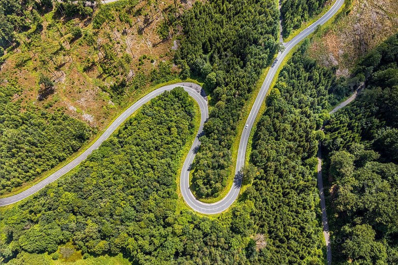 Aerial view, serpentines at the Ochsenkopf between Arnsberg and Sundern in the forest area with forest damage Stockumer Höhe, Sunderner Straße Landesstraße L685, Arnsberg, Sauerland, North Rhine-Westphalia, Germany, serpentines, Ochsenkopf, Sundern, forest area, forest damage, Stockumer Höhe, Sunderner Straße, Landesstraße L685, road, landscape, nature, forest, damage, trees, traffic, infrastructure, curves, altitude, rural, environment, vegetation, perspective, aerial view, environmental damage, region, geographical, tranquillity, green, sky, day