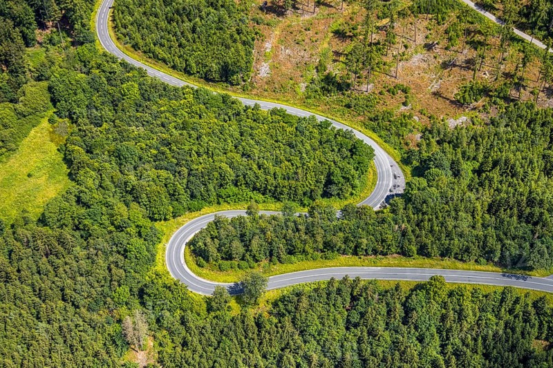 Aerial view, serpentines at the Ochsenkopf between Arnsberg and Sundern in the forest area with forest damage Stockumer Höhe, Sunderner Straße Landesstraße L685, Arnsberg, Sauerland, North Rhine-Westphalia, Germany, serpentines, Ochsenkopf, Sundern, forest area, forest damage, Stockumer Höhe, Sunderner Straße, Landesstraße L685, forest, trees, nature, landscape, road, traffic, damage, environmental damage, mountain, hill, curves, aerial view, autumn, drone shot, panorama, topography, environment, scenic, Europe, vegetation, infrastructure